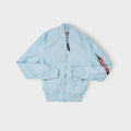 Alpha Industries bomber jacket in light blue with red Remove Before Flight tag on sleeve