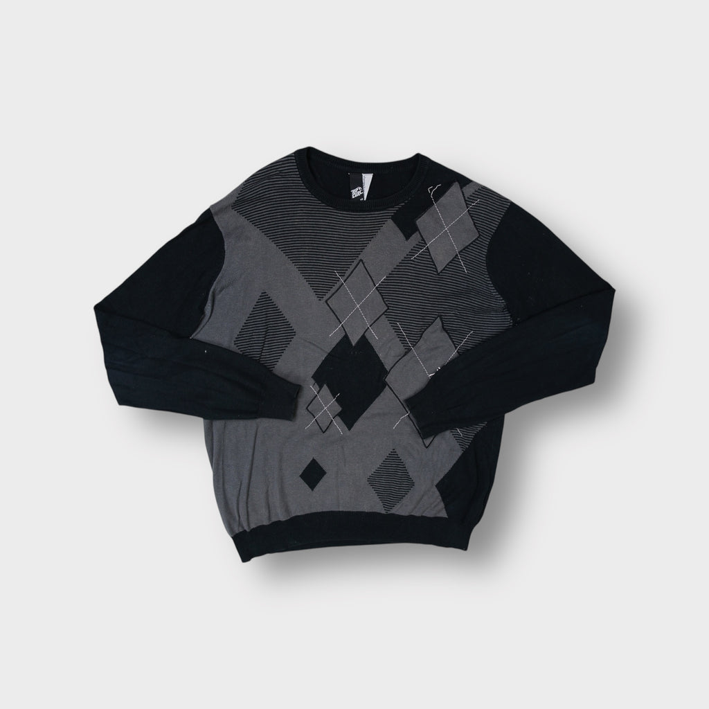 Rip Curl black knit sweater with a grey argyle pattern across the front