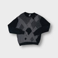 Rip Curl black knit sweater with a grey argyle pattern across the front