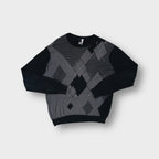 Rip Curl black knit sweater with a grey argyle pattern across the front