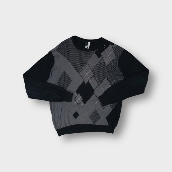Rip Curl black knit sweater with a grey argyle pattern across the front