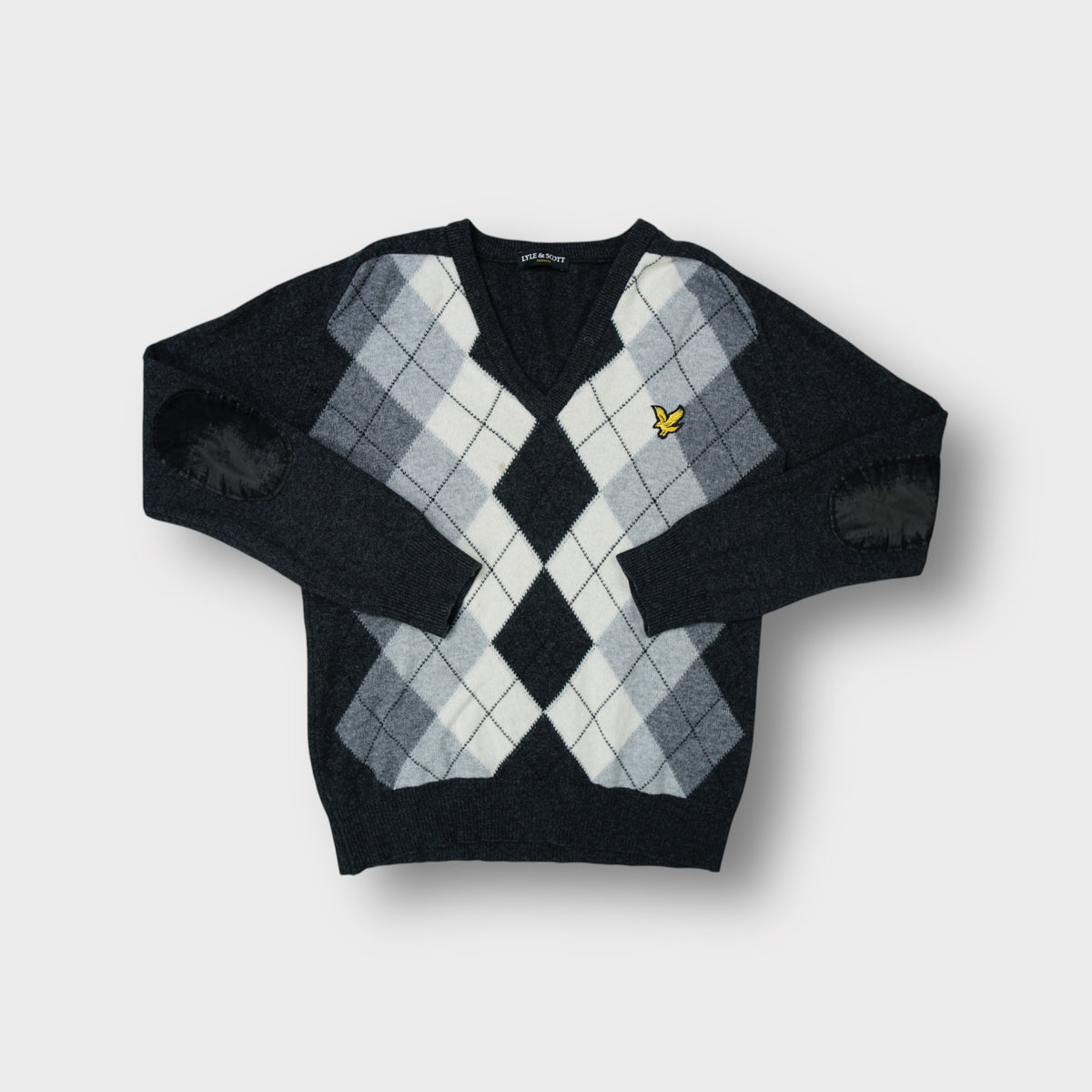 Lyle & Scott knit sweater in black with a grey argyle pattern and elbow patches