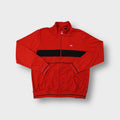Red Nike track jacket with a black chest band and small embroidered sneaker logo.
