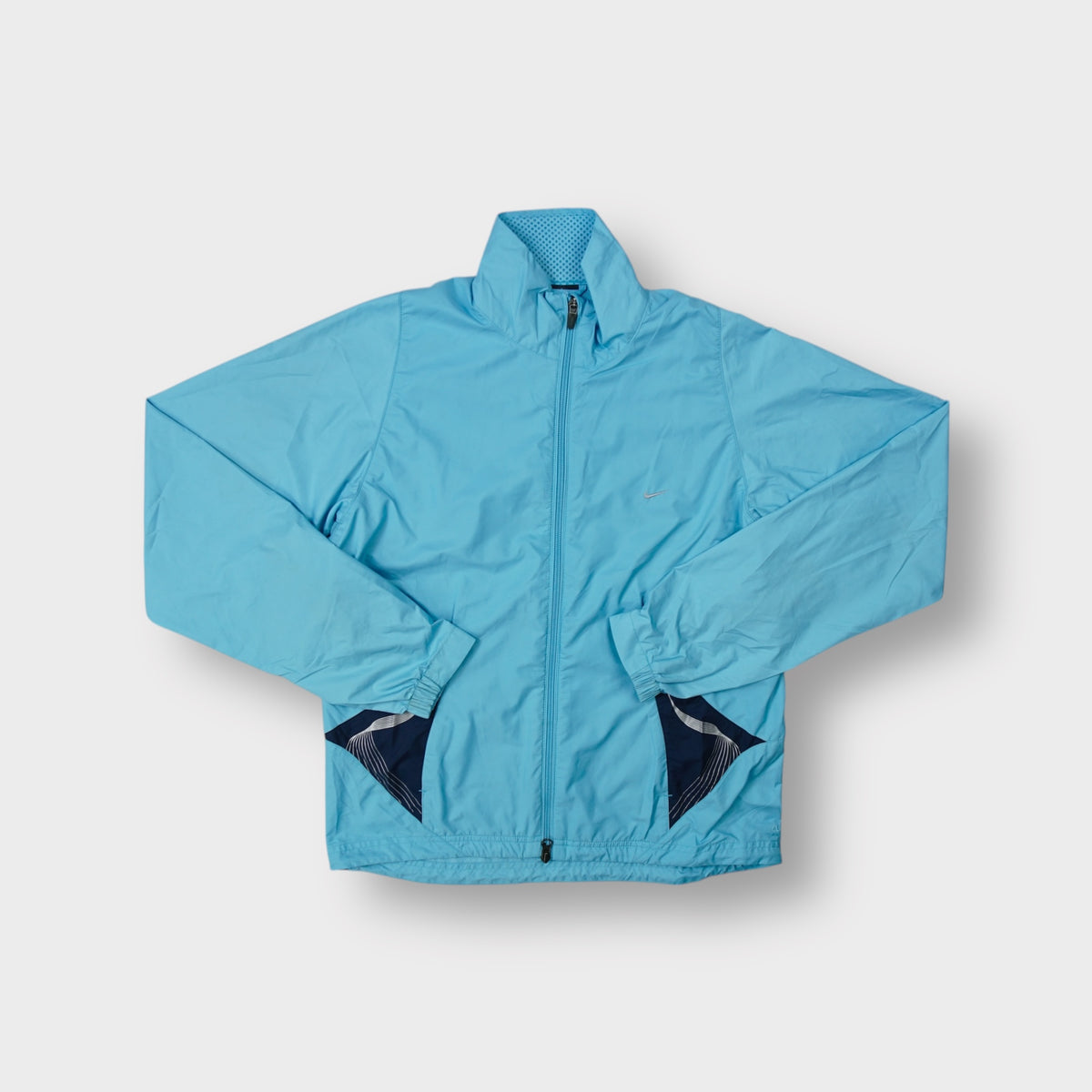 Nike lightweight track jacket in light blue with front zip and high collar