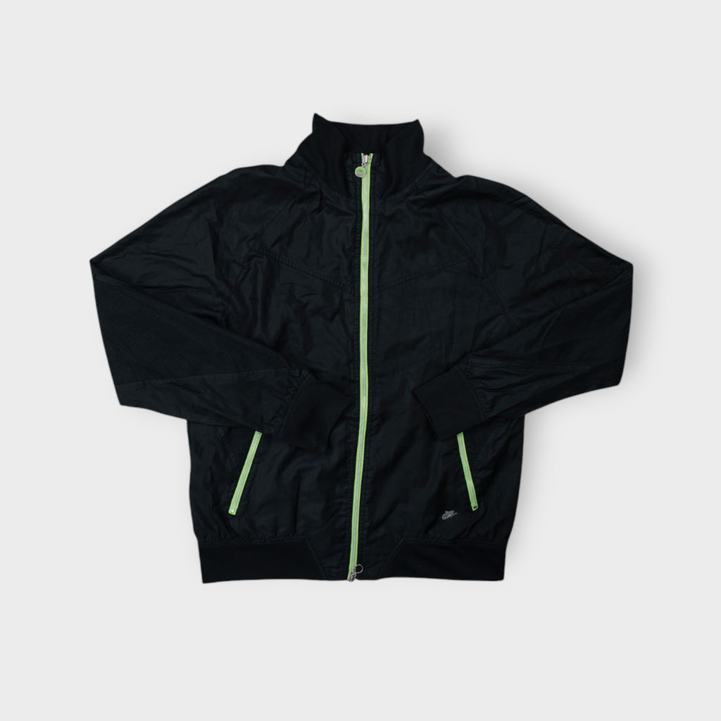 Nike jacket in black featuring a high collar and contrasting neon green zippers
