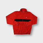 Nike track jacket in red featuring an embroidered sneaker patch and black chest band