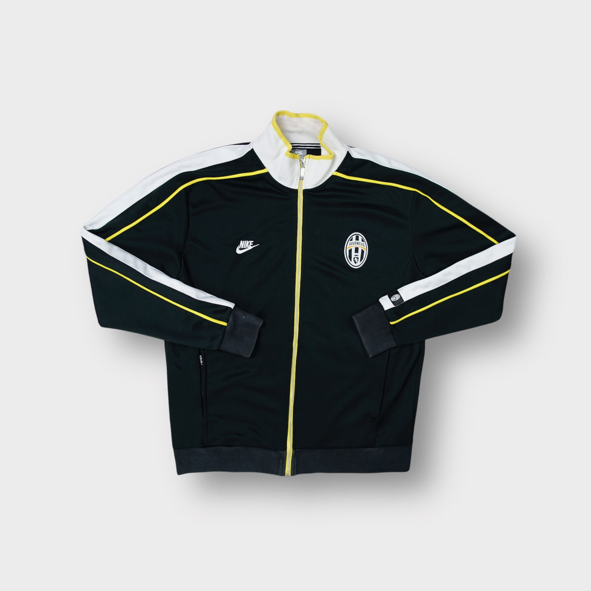 Nike Juventus track jacket in black with embroidered club crest and white shoulder trim