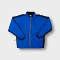 Nike track jacket in blue featuring an embroidered black swoosh on the chest and a full front zip