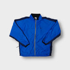 Nike track jacket in blue featuring an embroidered black swoosh on the chest and a full front zip