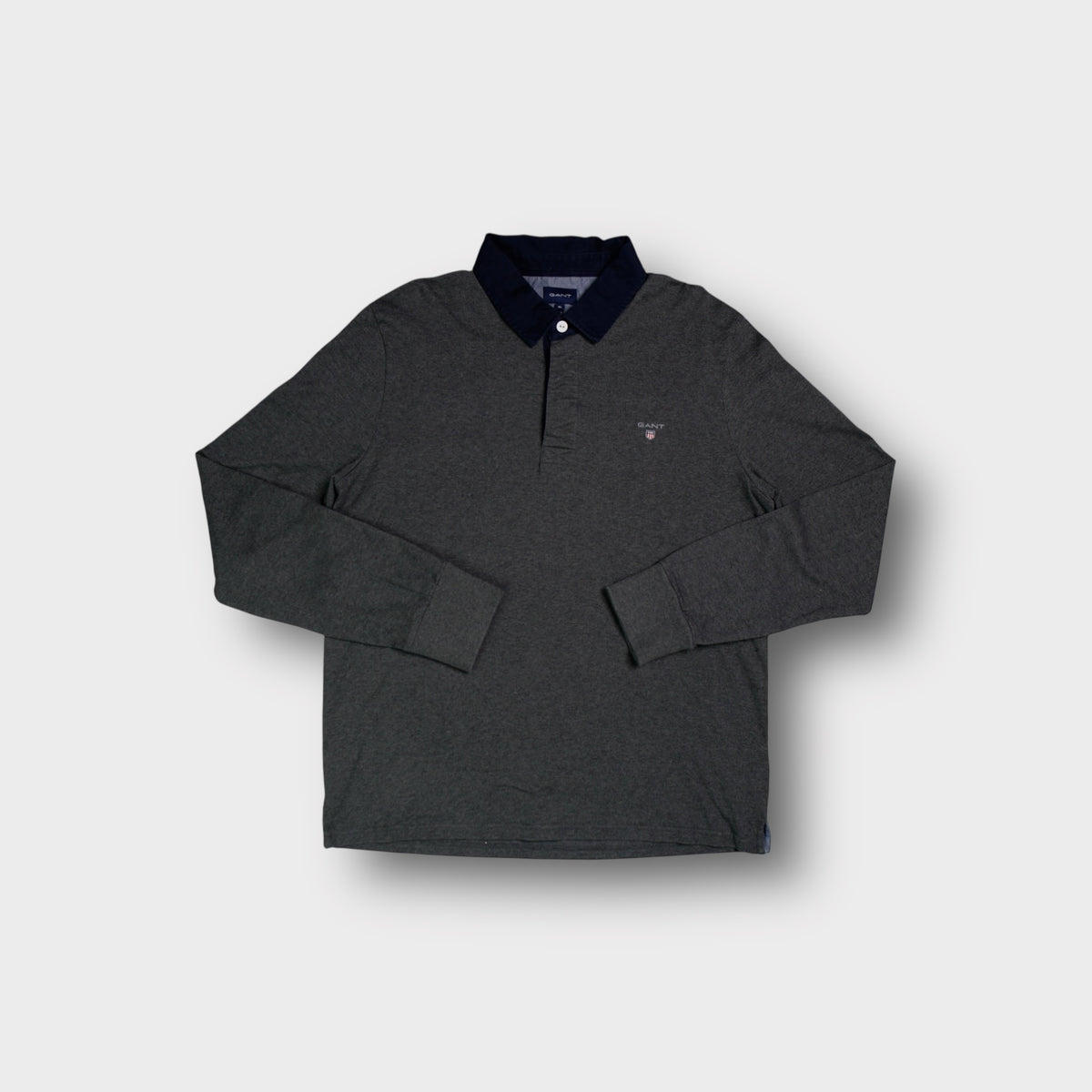 Dark grey Gant long-sleeve polo sweater with a dark blue collar and chest logo.