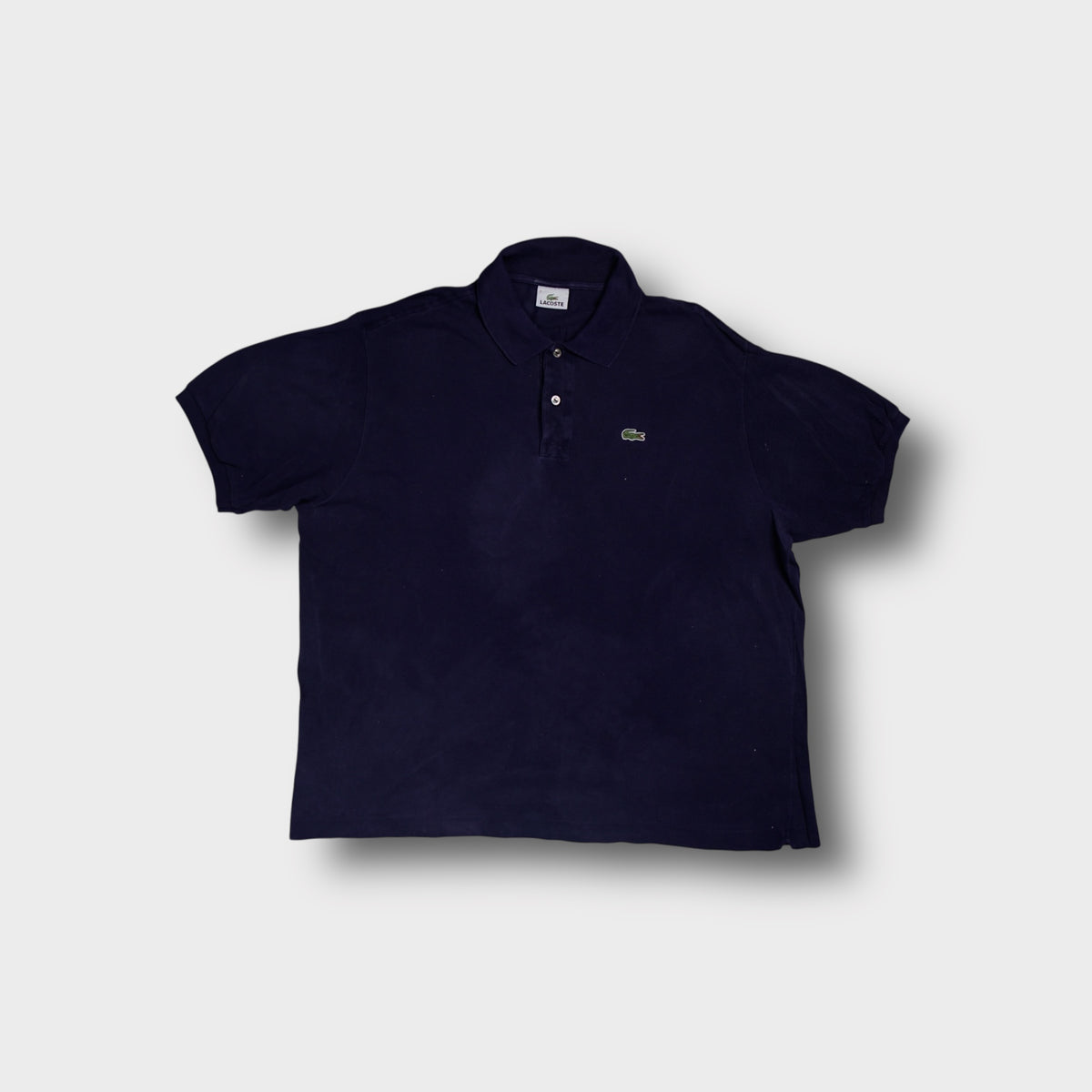 Lacoste polo shirt in navy blue featuring the embroidered crocodile logo patch on the chest