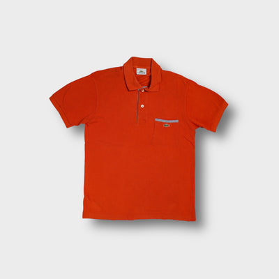 Red Lacoste polo shirt with striped trim details and embroidered crocodile logo patch