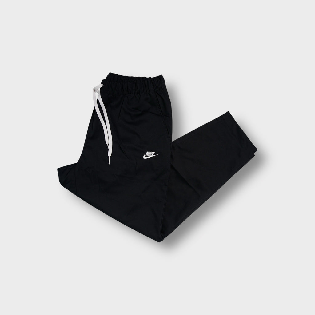 Black Nike trackpants with white embroidered small logo and elastic drawstring waist