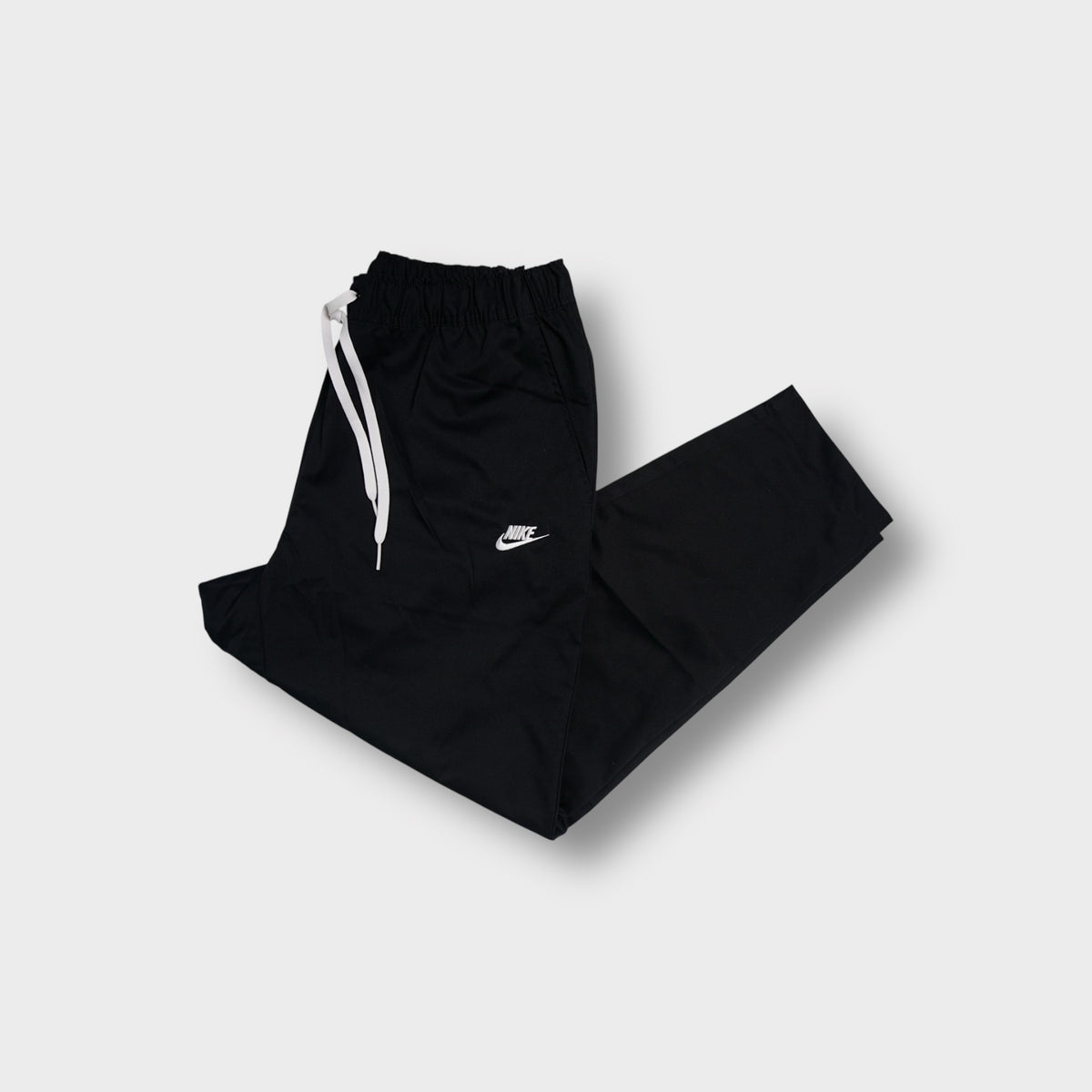 Black Nike trackpants with white embroidered small logo and elastic drawstring waist