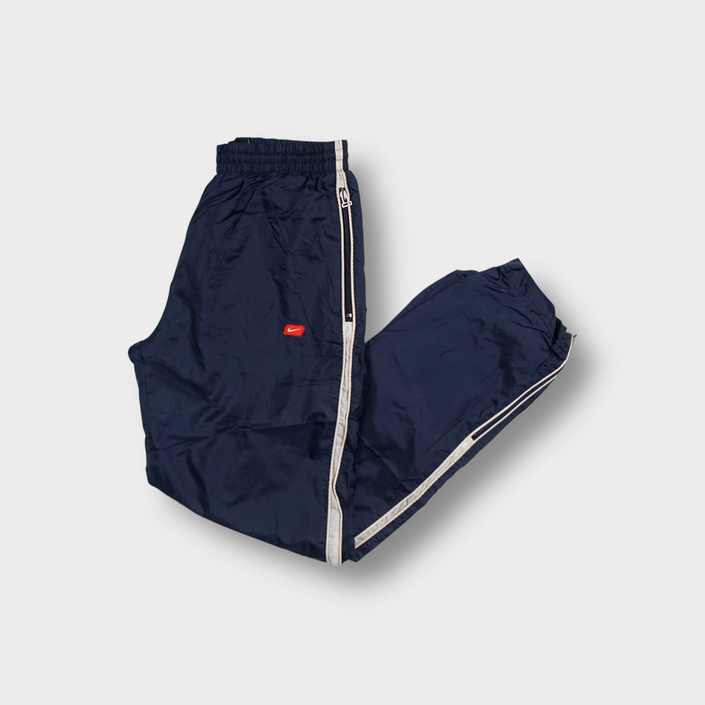 Nike trackpants in blue with white side piping and small embroidered swoosh logo