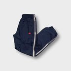 Nike trackpants in blue with white side piping and small embroidered swoosh logo