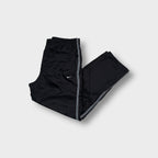 Nike trackpants in black with contrast side piping and an embroidered swoosh logo