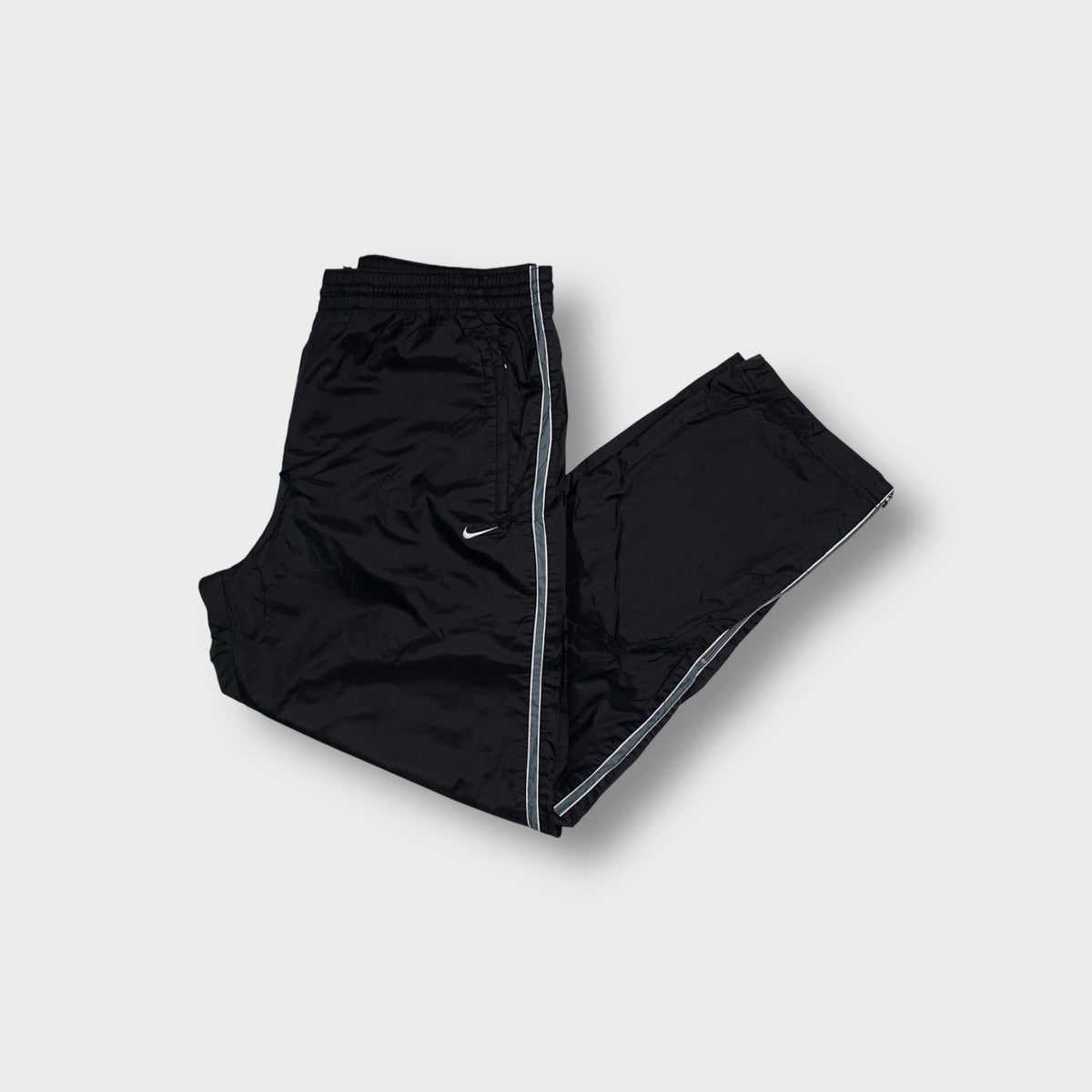 Nike trackpants in black with contrast side piping and an embroidered swoosh logo
