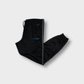 Black Adidas trackpants with side stripes, turquoise logo embroidery, and ribbed cuffs