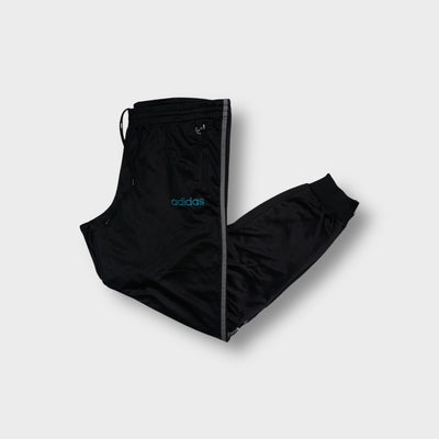 Black Adidas trackpants with side stripes, turquoise logo embroidery, and ribbed cuffs