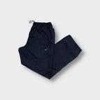 Adidas trackpants in navy blue with a small embroidered logo on the thigh