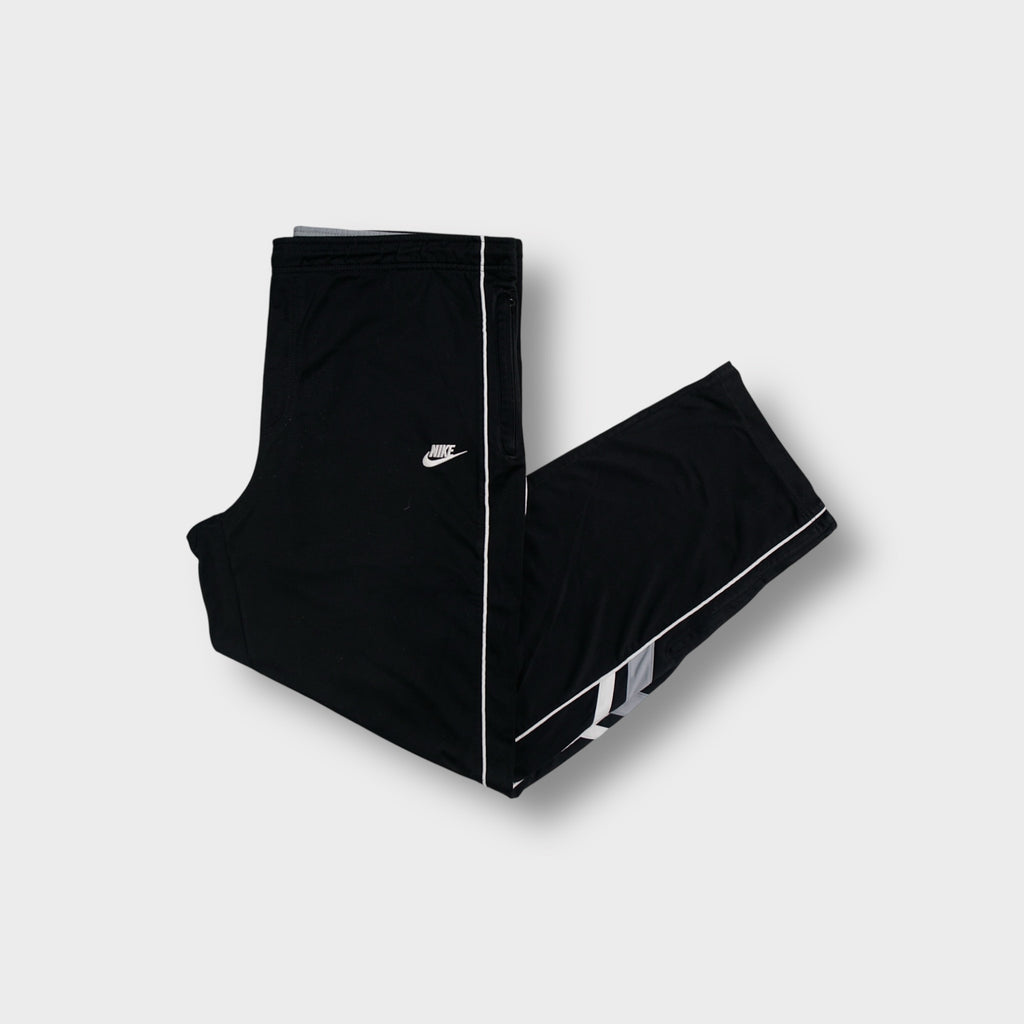 Nike trackpants in black with white side piping and embroidered swoosh logo
