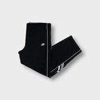 Nike trackpants in black with white side piping and embroidered swoosh logo