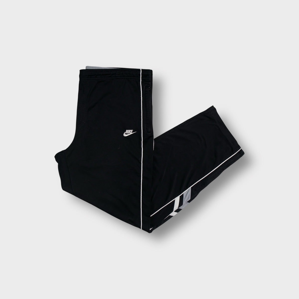 Nike trackpants in black with white side piping and embroidered swoosh logo