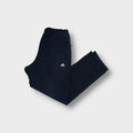 Adidas navy blue trackpants featuring an embroidered white Performance logo on the thigh