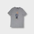 Grey Ralph Lauren T-Shirt featuring a central Polo Bear print wearing denim