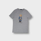 Grey Ralph Lauren T-Shirt featuring a central Polo Bear print wearing denim
