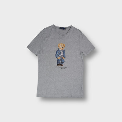 Grey Ralph Lauren T-Shirt featuring a central Polo Bear print wearing denim