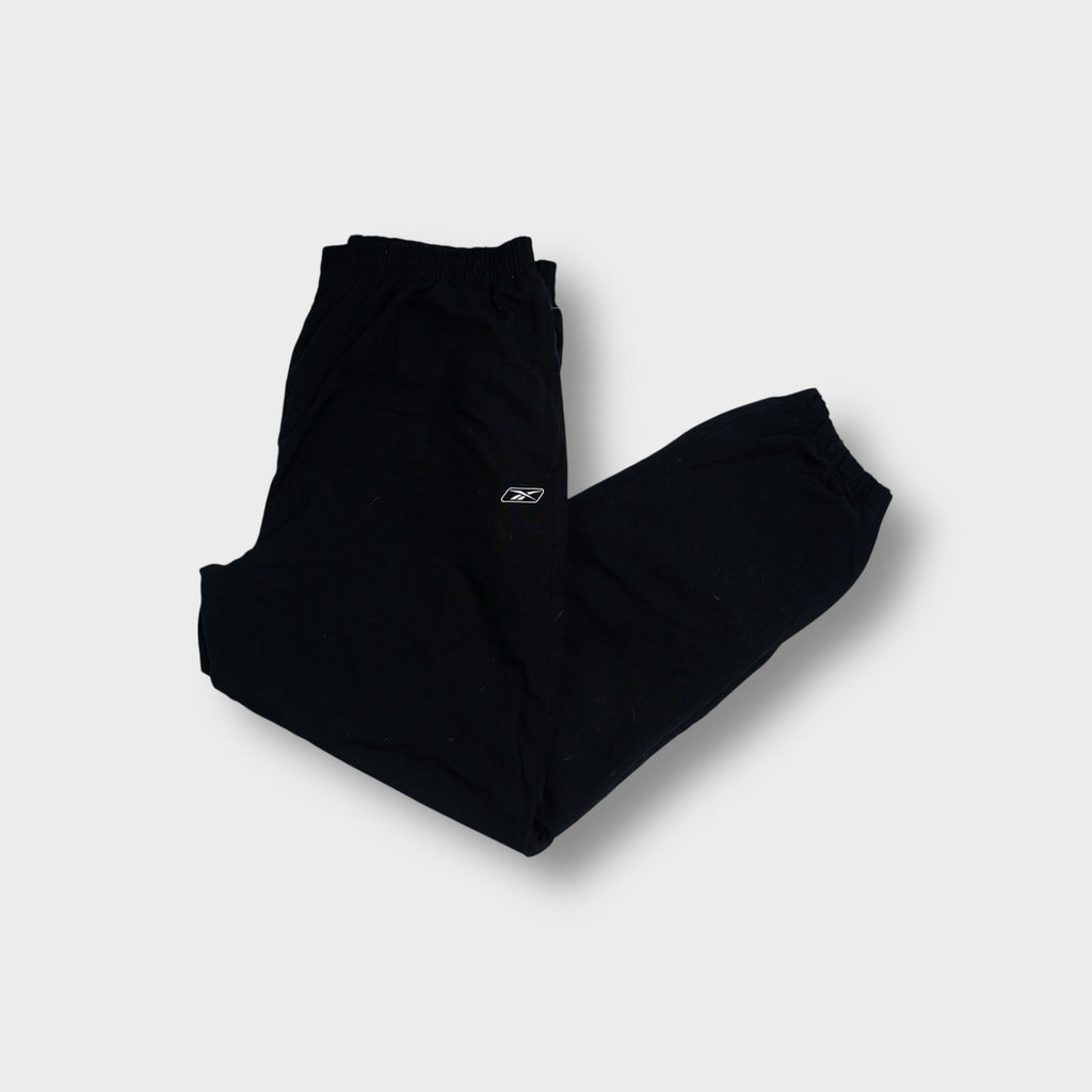 Reebok trackpants in navy blue featuring an embroidered vector logo on the upper leg