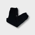 Reebok trackpants in navy blue featuring an embroidered vector logo on the upper leg