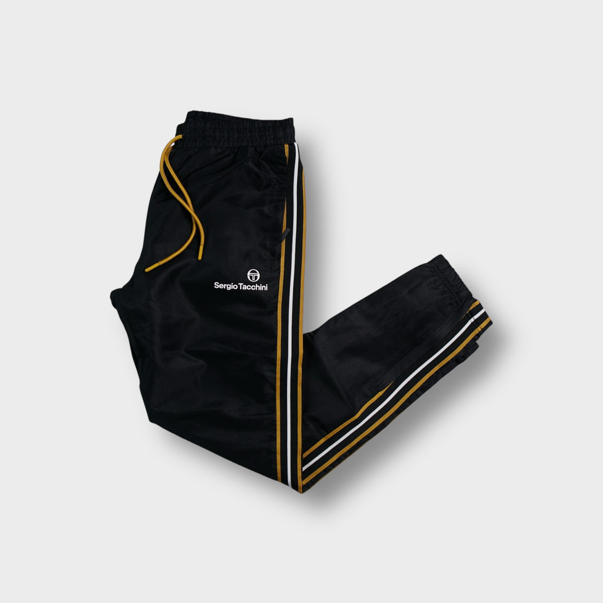 Sergio Tacchini trackpants in black with yellow drawstrings and side stripes