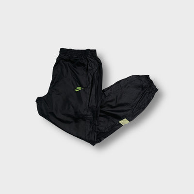 Black Nike trackpants with neon green embroidered logo and pink side panels