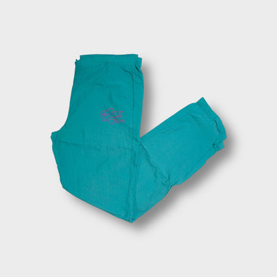 Adidas turquoise trackpants with pink Spirit of the Games embroidery on hip