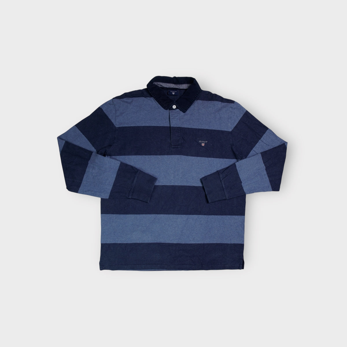 Gant long-sleeve blue striped polo sweater featuring an embroidered shield crest logo.