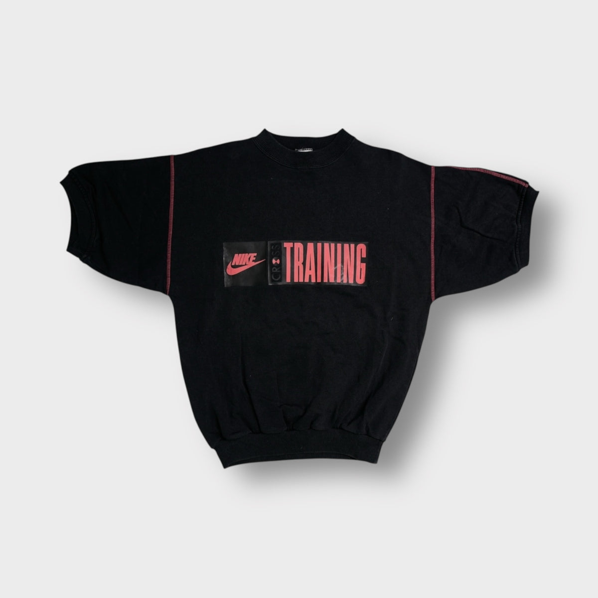 Black Nike sweatshirt with red Cross Training chest print and short wide sleeves.