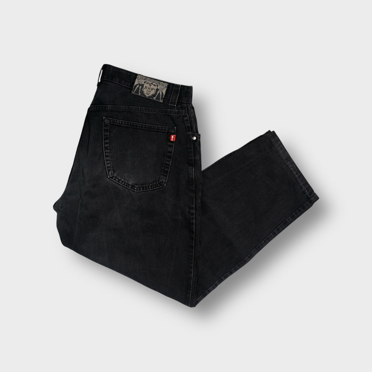 Joop jeans in black featuring a detailed leather back patch on the waistband