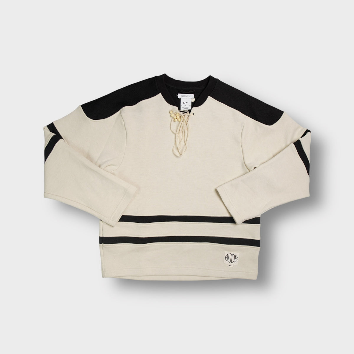 Nike x Bode beige knit sweater with front lacing and black shoulder panels
