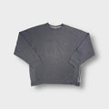 Nike grey crewneck sweater featuring a small embroidered swoosh logo on the chest