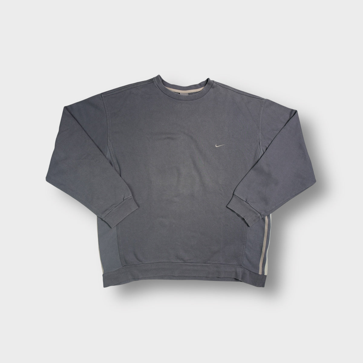 Nike grey crewneck sweater featuring a small embroidered swoosh logo on the chest