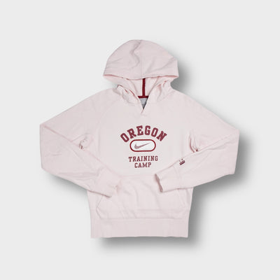 Rose Nike hoodie featuring a maroon Oregon Training Camp chest graphic print.
