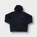 Nike hoodie in black with a small white embroidered swoosh on the chest.