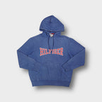 Blue Tommy Hilfiger pullover hoodie with red and white stitched Hilfiger chest appliqué.