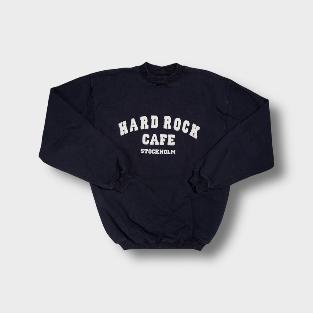 Hard Rock Cafe navy blue sweater with white Stockholm arch logo text across chest