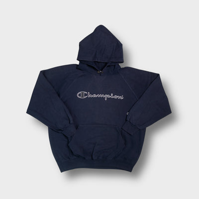 Champion hoodie in navy blue featuring an embroidered script logo across the chest.