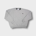 Grey Champion sweater with small embroidered logo on chest and ribbed cuffs.