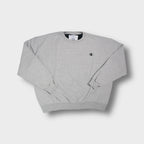 Grey Champion sweater with small embroidered logo on chest and ribbed cuffs.